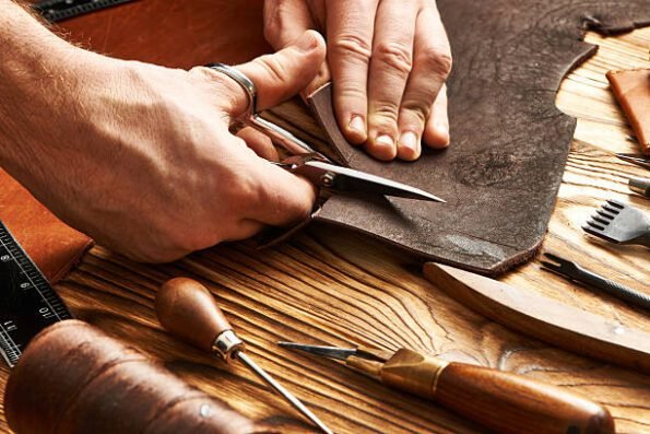 Man working with leather using crafting DIY tools