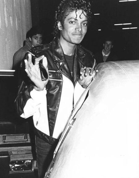 MICHAEL JACKSON wearing a LEATHER JACKET about to sit into his car ,