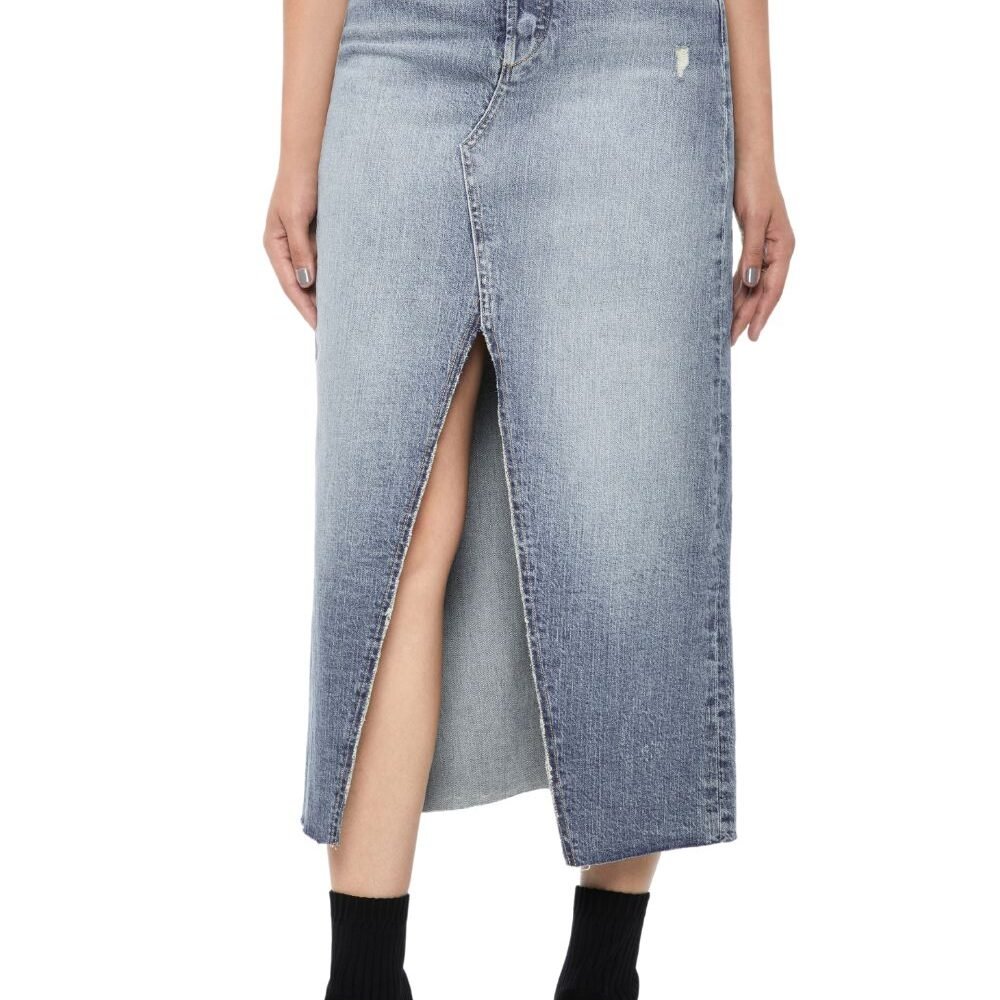 A woman wearing a Vintage Wash Front-Slit denim skirt with a front slit and black ankle boots.