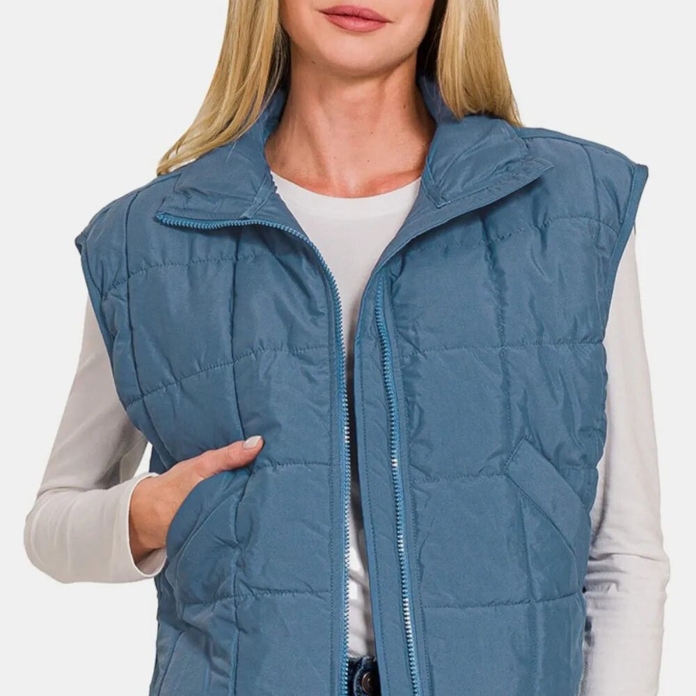 stylish Zip Up Cropped Puffer Vest, front view in blue puffer vest a women with grey hairs possing wearing blue puffer jacket